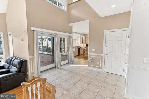 a dining room with furniture a chandelier and wooden floor