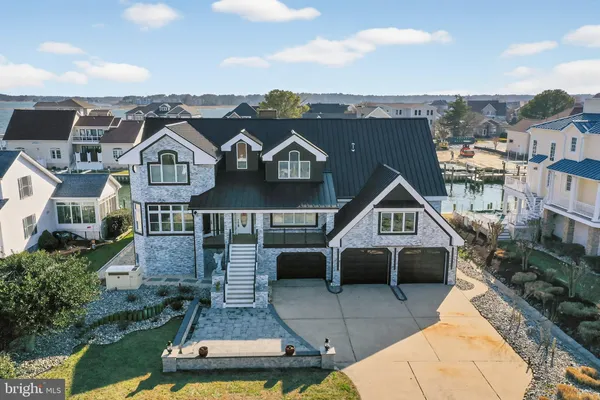a front view of a house with swimming pool and porch