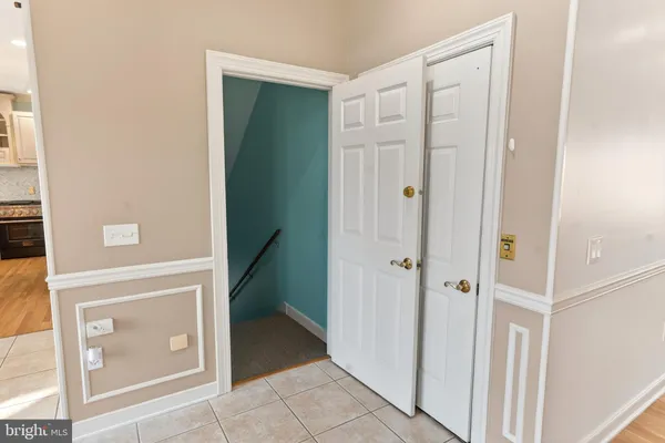a view of a hallway with wooden floor and entryway