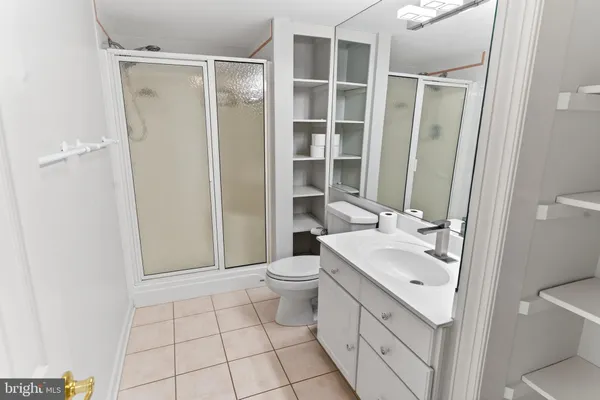 a bedroom with a bed and a dresser next to a window