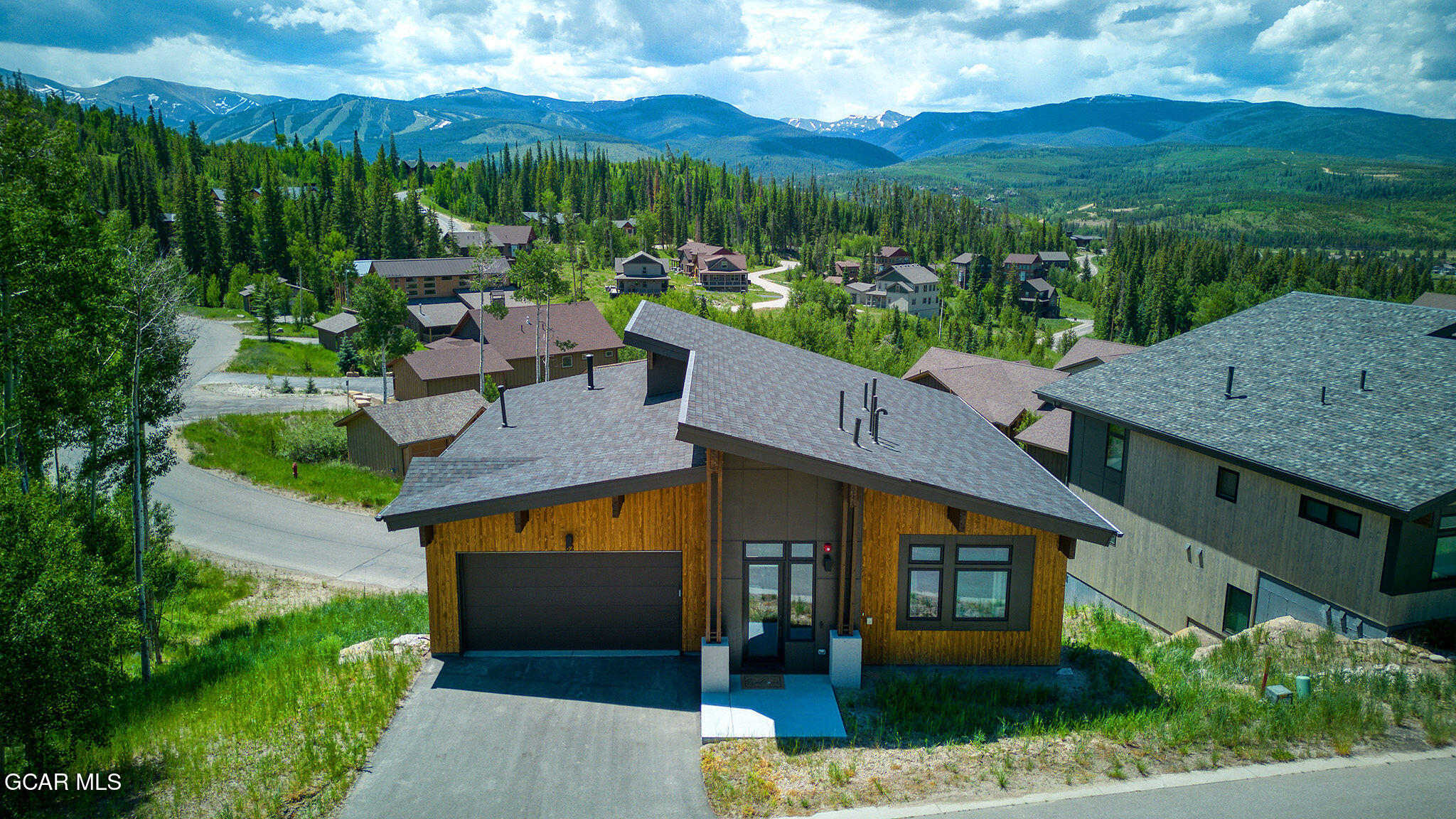 aerial view of a house with a yard and potted plants