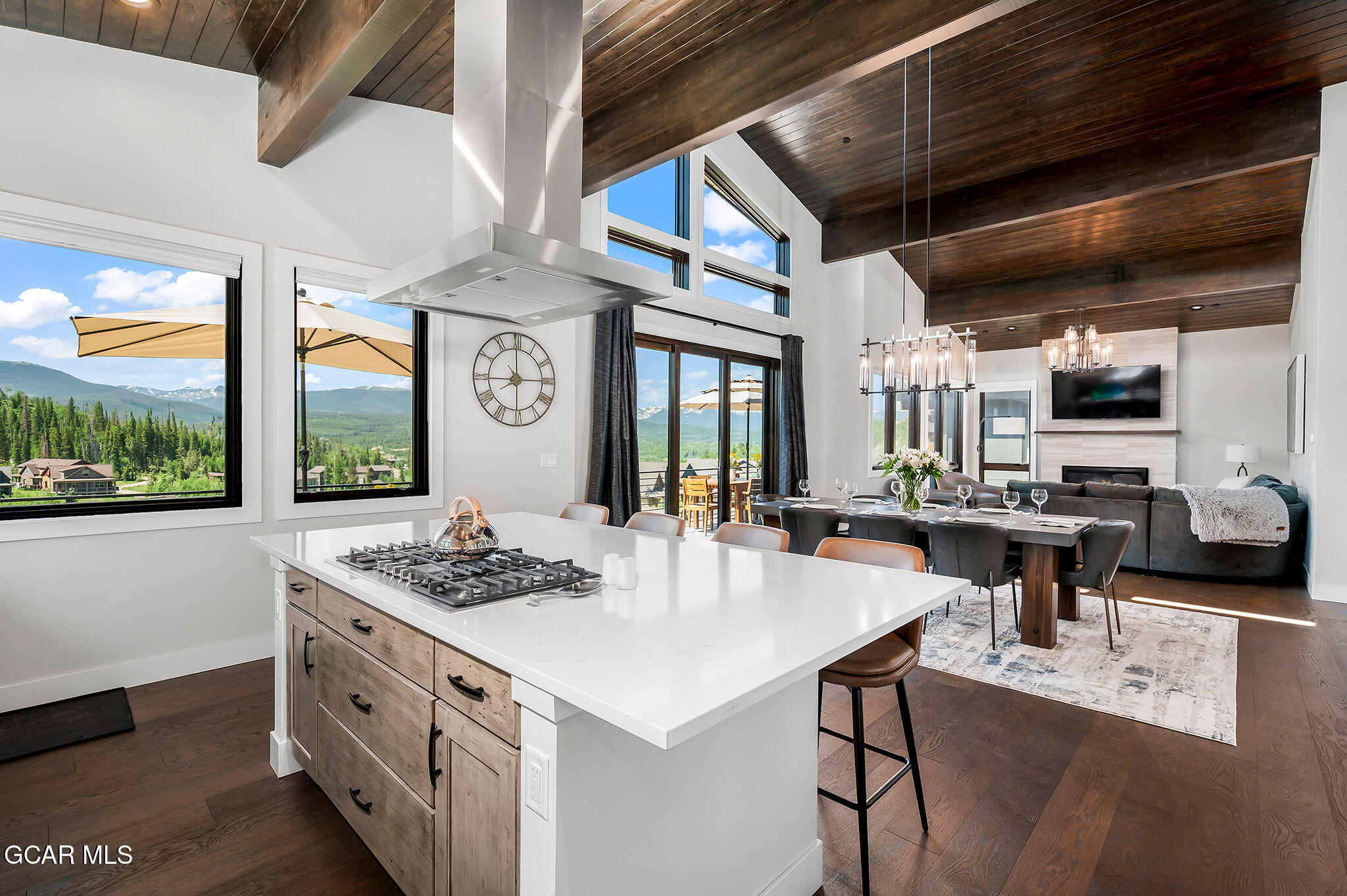 82 Game Trail Fraser, CO 80442 - Photo 12 of 51 a kitchen with stainless steel appliances granite countertop a stove a refrigerator a kitchen island with a stove and white cabinets