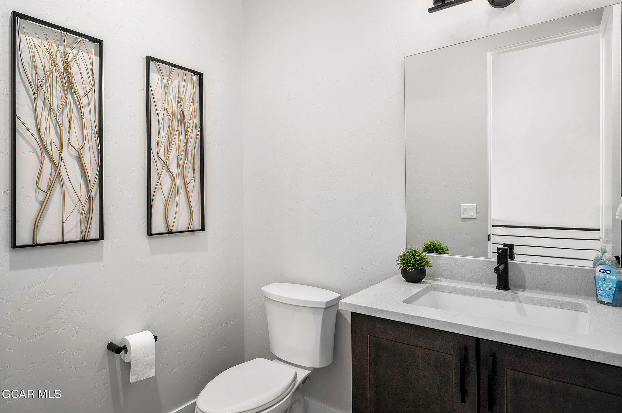 82 Game Trail Fraser, CO 80442 - Photo 13 of 51 a bathroom with a granite countertop sink and a toilet