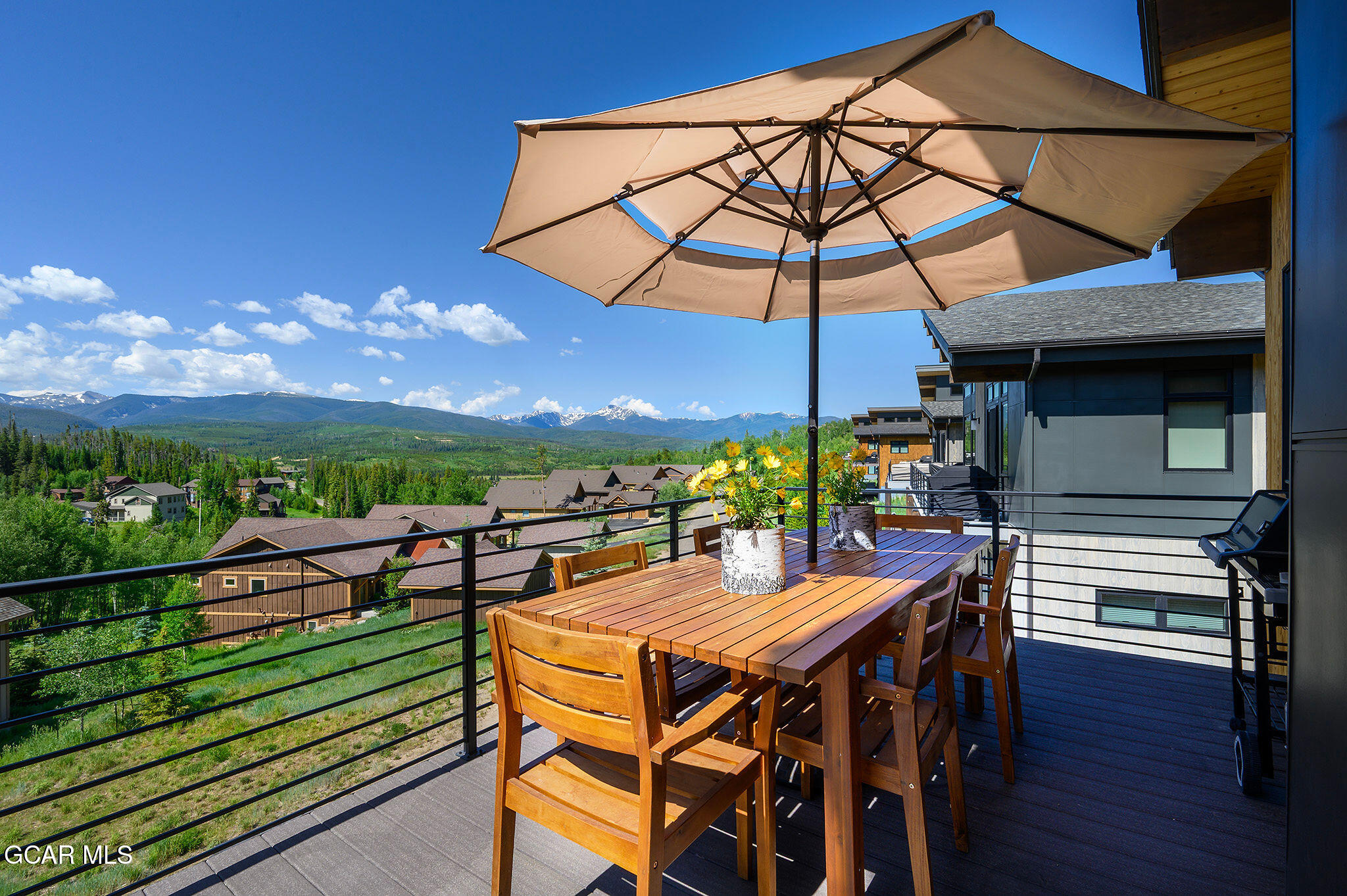 82 Game Trail Fraser, CO 80442 - Photo 16 of 51 a view of a patio with a table chairs and a umbrella