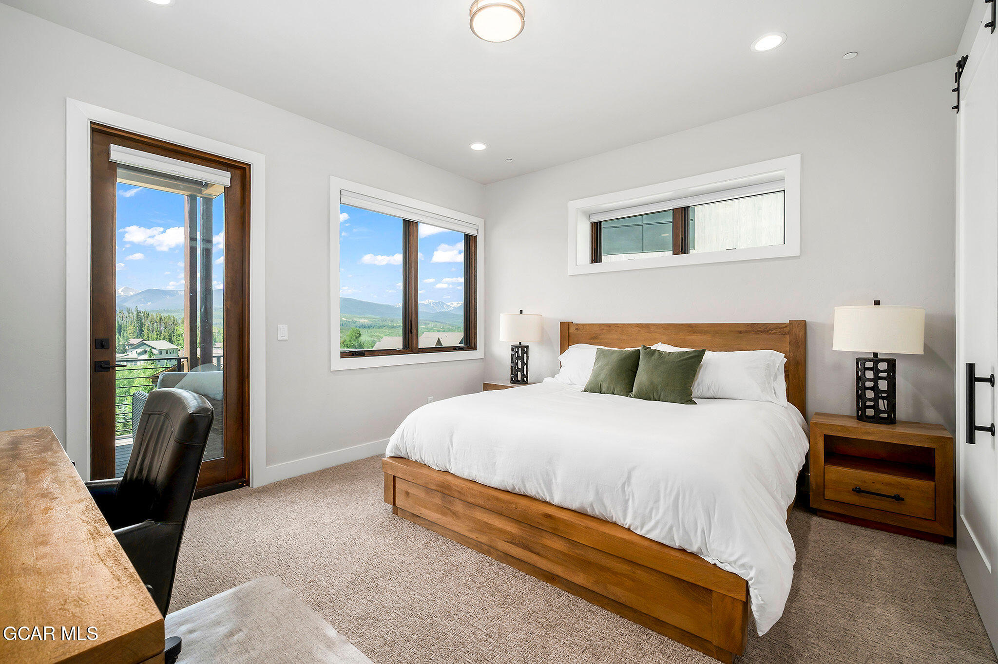 82 Game Trail Fraser, CO 80442 - Photo 27 of 51 a spacious bedroom with a bed and glass door