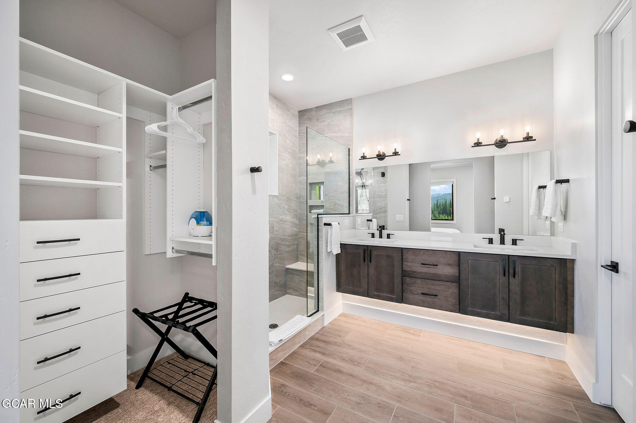 82 Game Trail Fraser, CO 80442 - Photo 29 of 51 a spacious bathroom with a granite countertop sink mirror and a bathtub