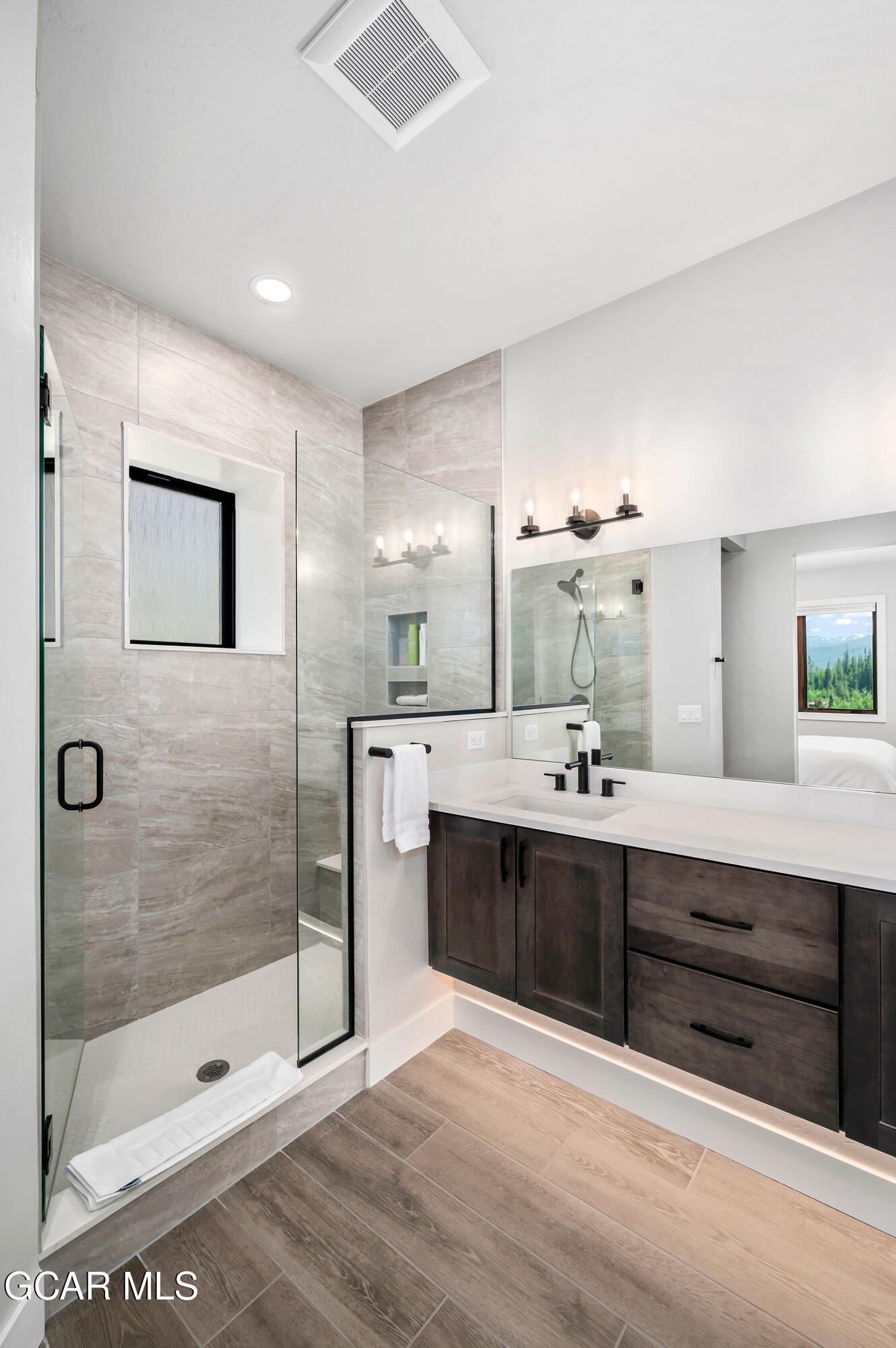 82 Game Trail Fraser, CO 80442 - Photo 30 of 51 a spacious bathroom with a shower sink and mirror