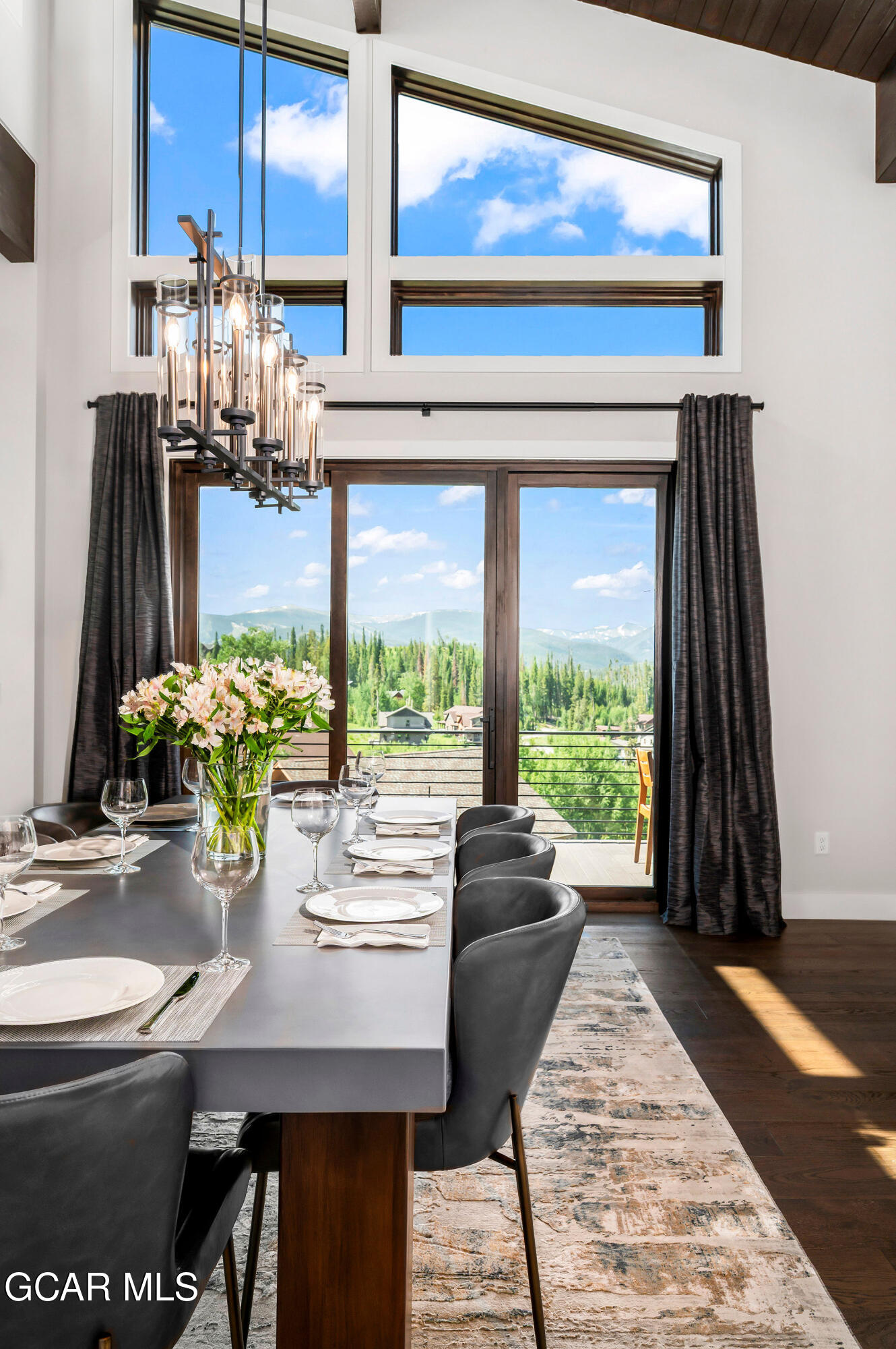 82 Game Trail Fraser, CO 80442 - Photo 7 of 51 a dining room with furniture and a floor to ceiling window