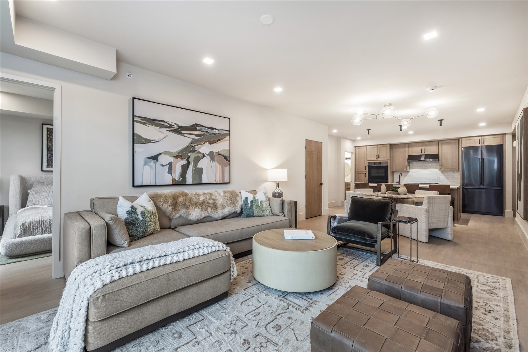 a living room with furniture and view of kitchen