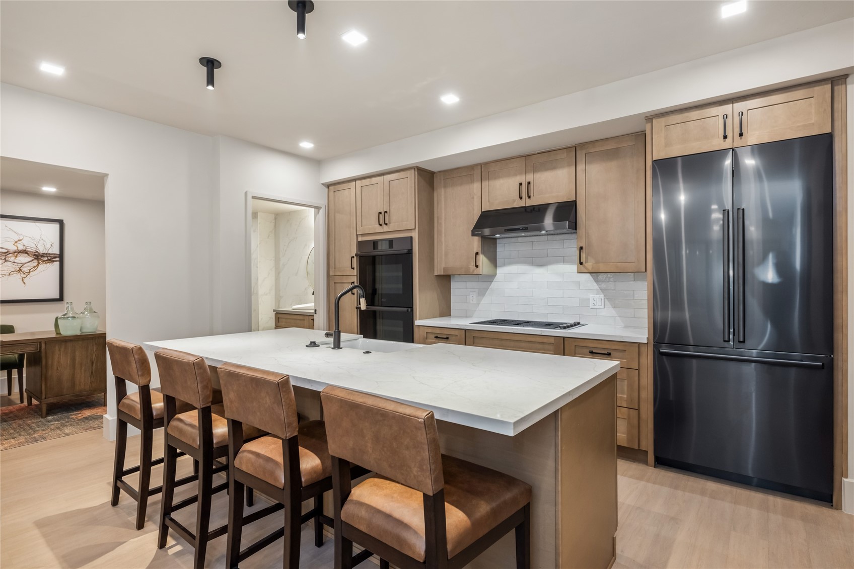 80 West Main Street, Unit 305 Frisco, CO 80443 - Photo 30 of 46 a kitchen with stainless steel appliances refrigerator dining table and chairs