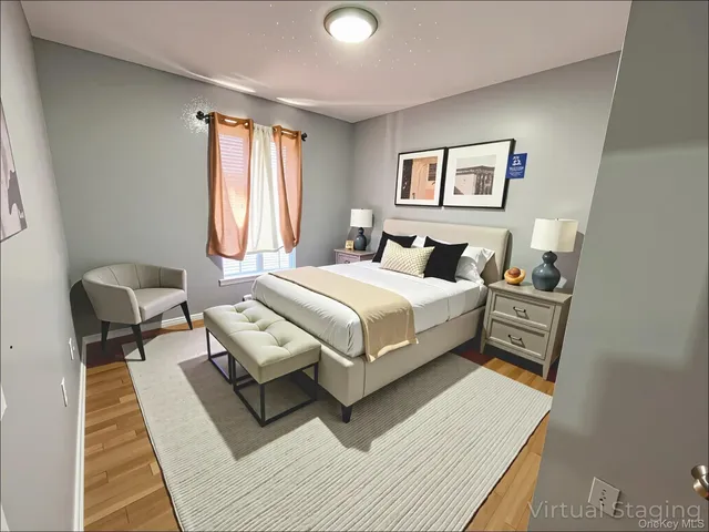 a bedroom with a bed a couch and a window