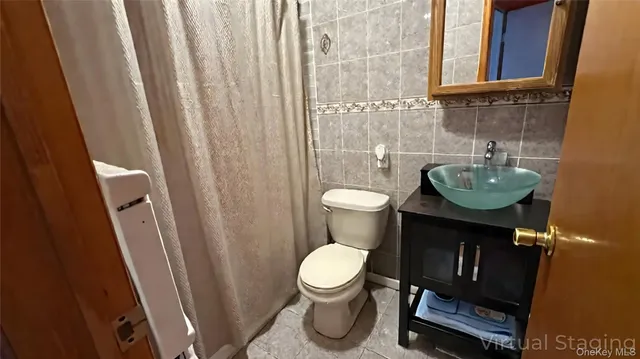 a bathroom with a toilet and a sink