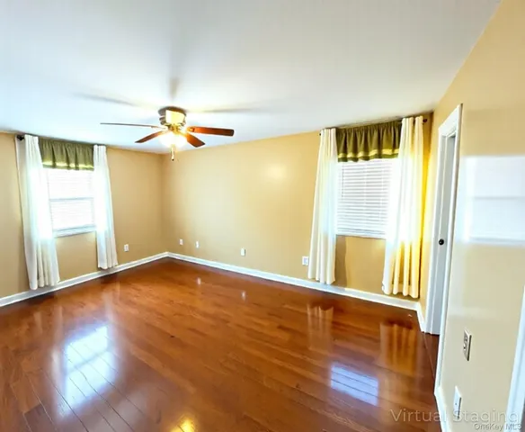 a view of a room with wooden floor and a window