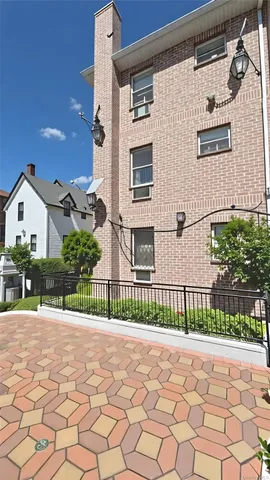 a view of a house with a small yard and wooden fence