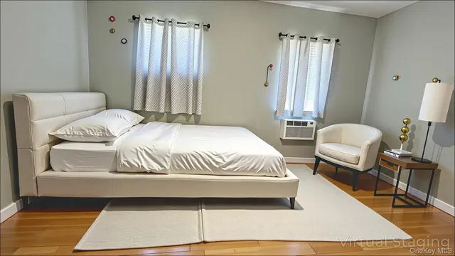 a bedroom with a bed a mirror and a window