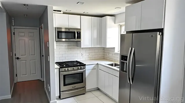 a kitchen with a refrigerator stove and microwave