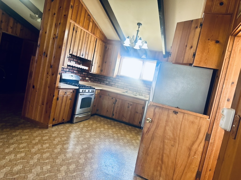 1111 North Bell Avenue Pontiac, IL 61764 - Photo 5 of 35 a view of a kitchen with stainless steel appliances wooden floor and staircase