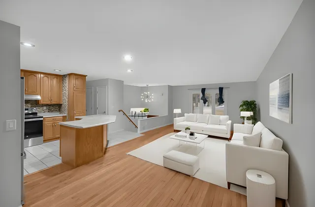 a living room with furniture and a kitchen