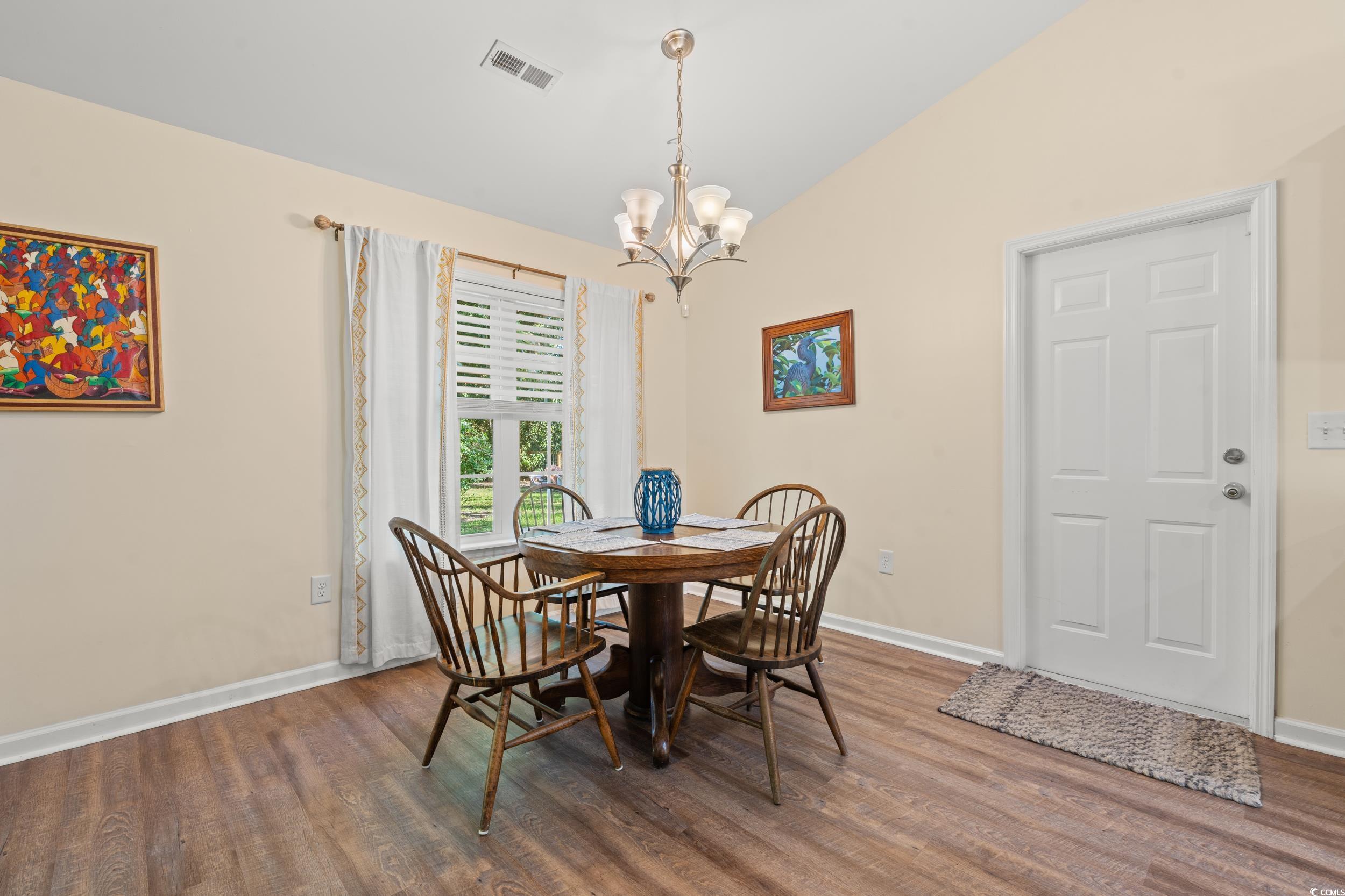 1208 10th Avenue Conway, SC 29526 - Photo 8 of 34 Dining area with lofted ceiling, a notable chandel