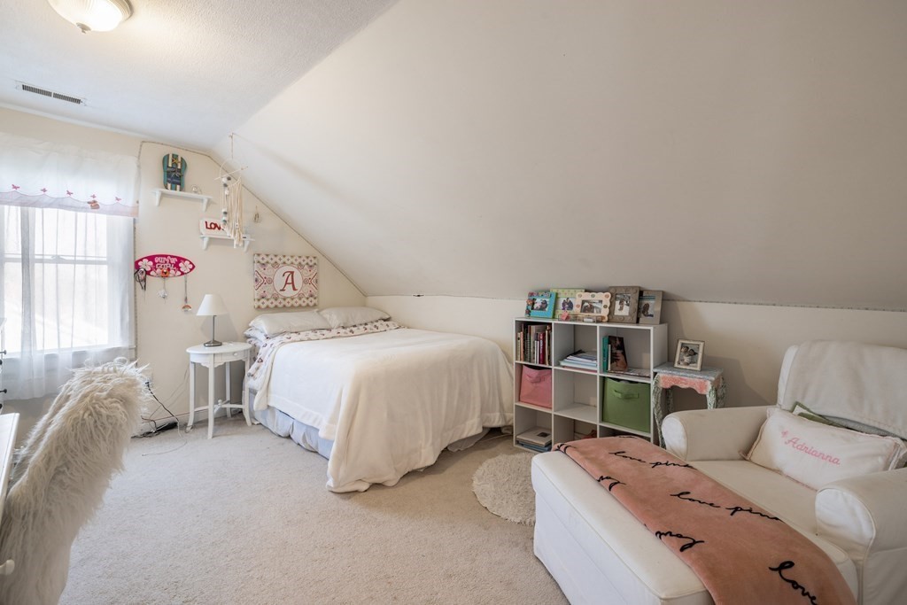 18 Harris Street Clinton, MA 01510 - Photo 20 of 31 a bed room with a bed and a book shelf