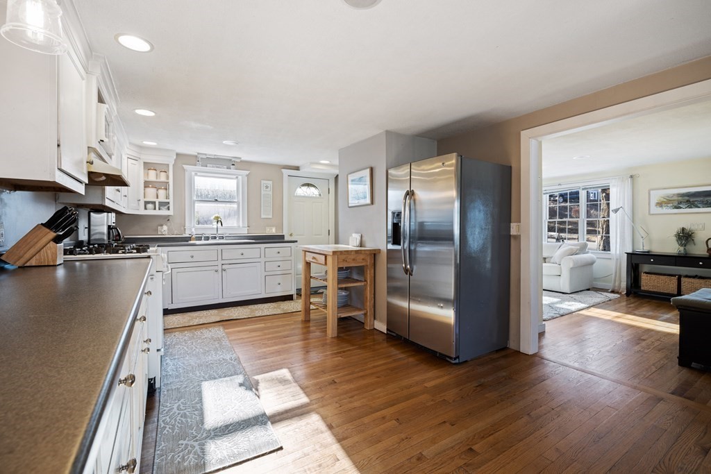 18 Harris Street Clinton, MA 01510 - Photo 3 of 31 a kitchen with stainless steel appliances kitchen island granite countertop a refrigerator a stove and a sink with wooden floor