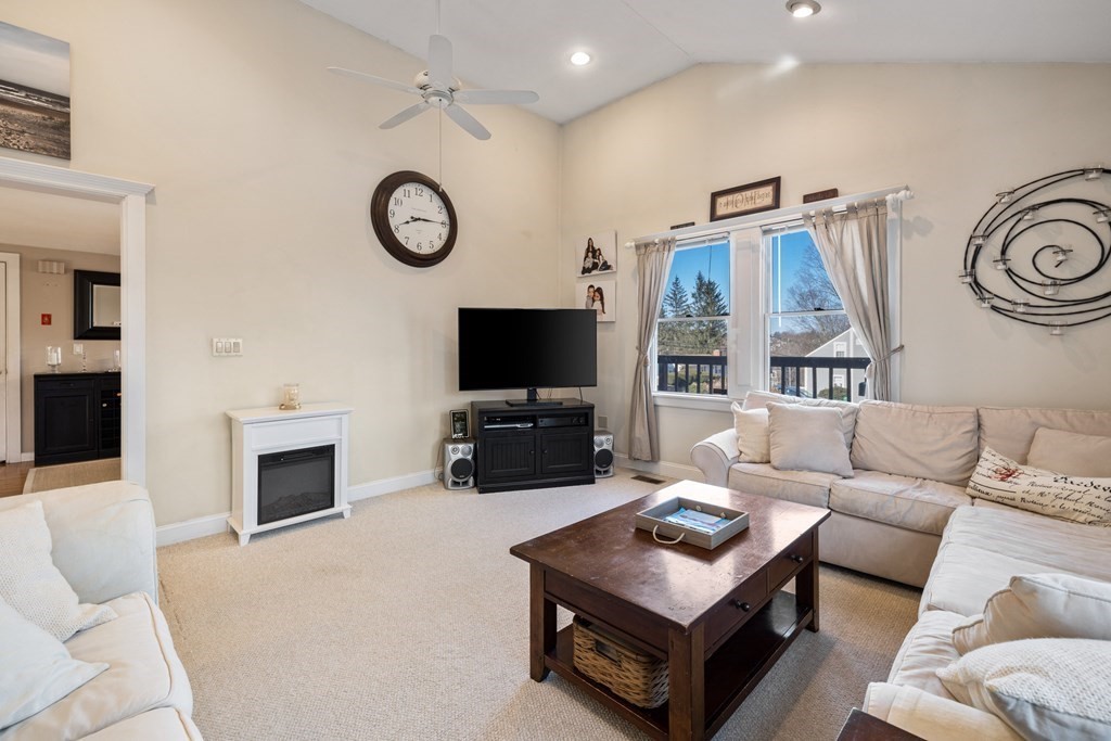 18 Harris Street Clinton, MA 01510 - Photo 10 of 31 a living room with furniture a flat screen tv and a fireplace