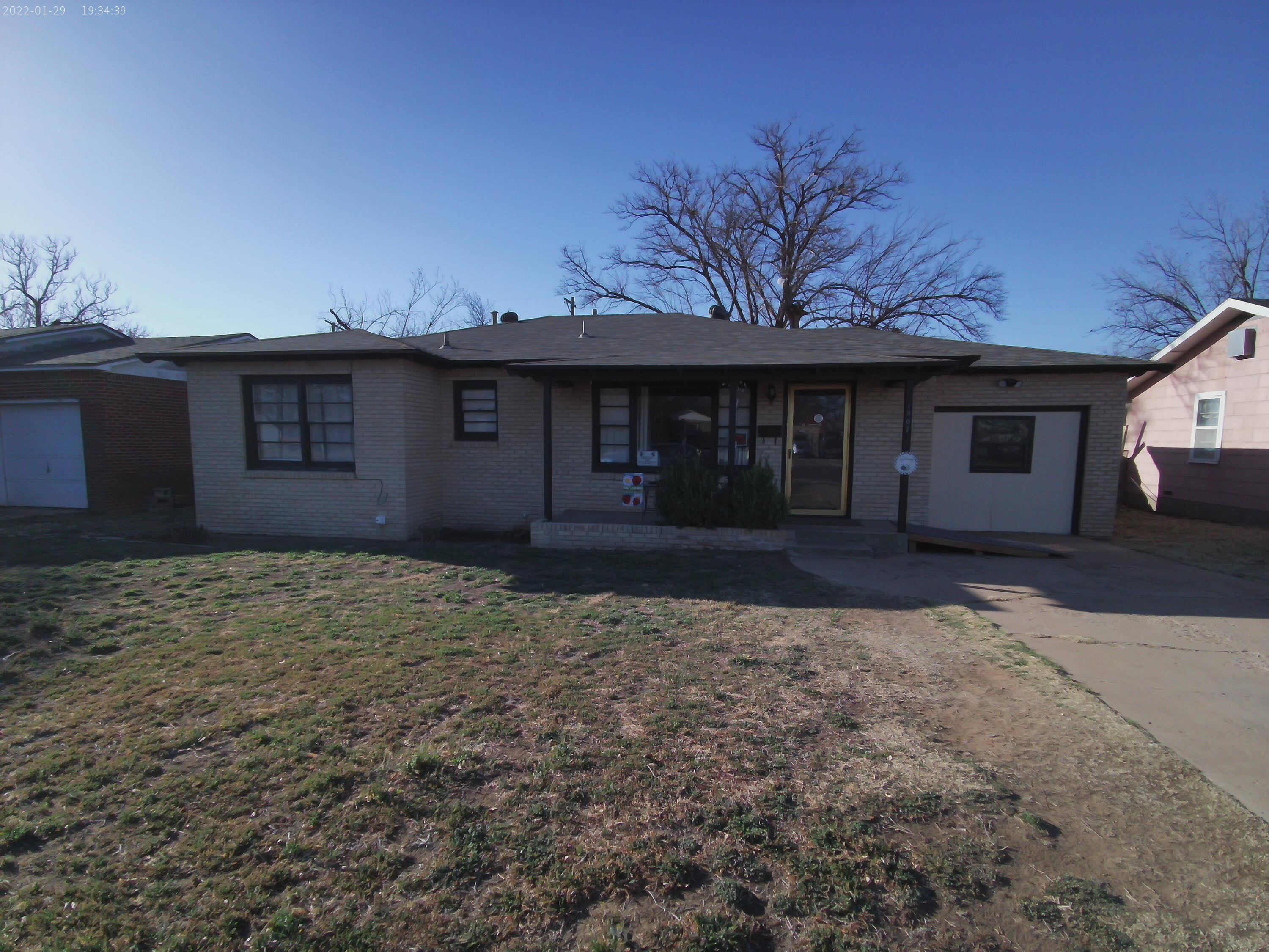 1907 38th Street Lubbock, TX 79412 - Photo 1 of 36 front view of a house with a yard