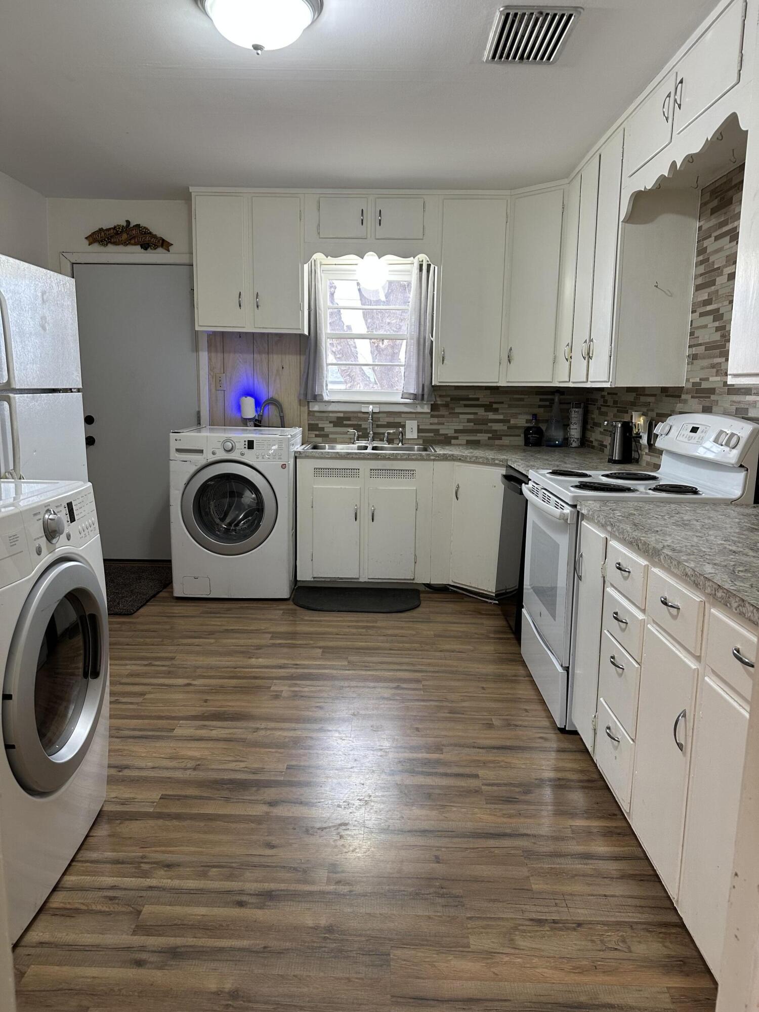1907 38th Street Lubbock, TX 79412 - Photo 11 of 36 a kitchen with a stove top oven sink and cabinets