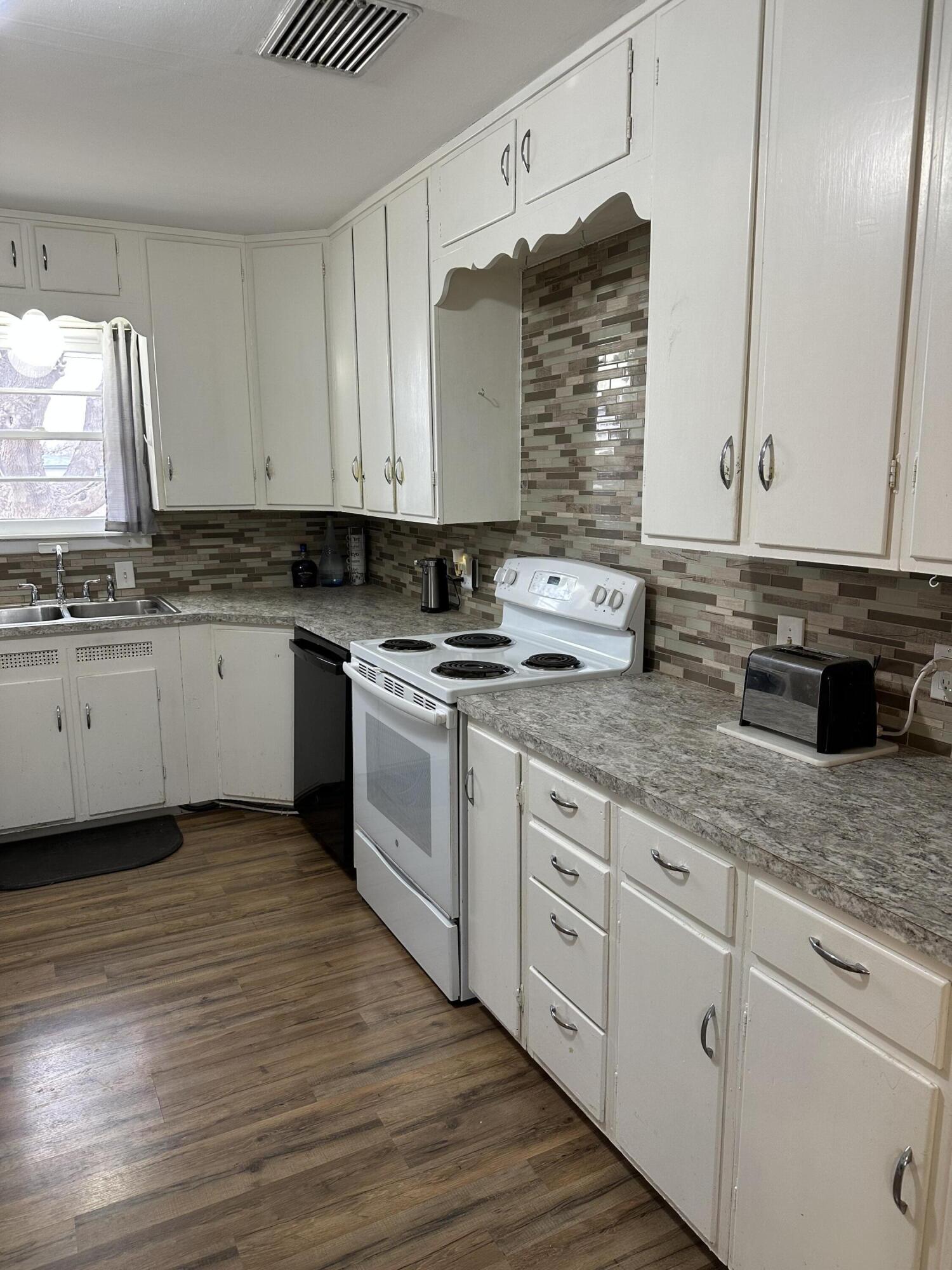 1907 38th Street Lubbock, TX 79412 - Photo 13 of 36 a kitchen with stainless steel appliances granite countertop a sink stove and cabinets