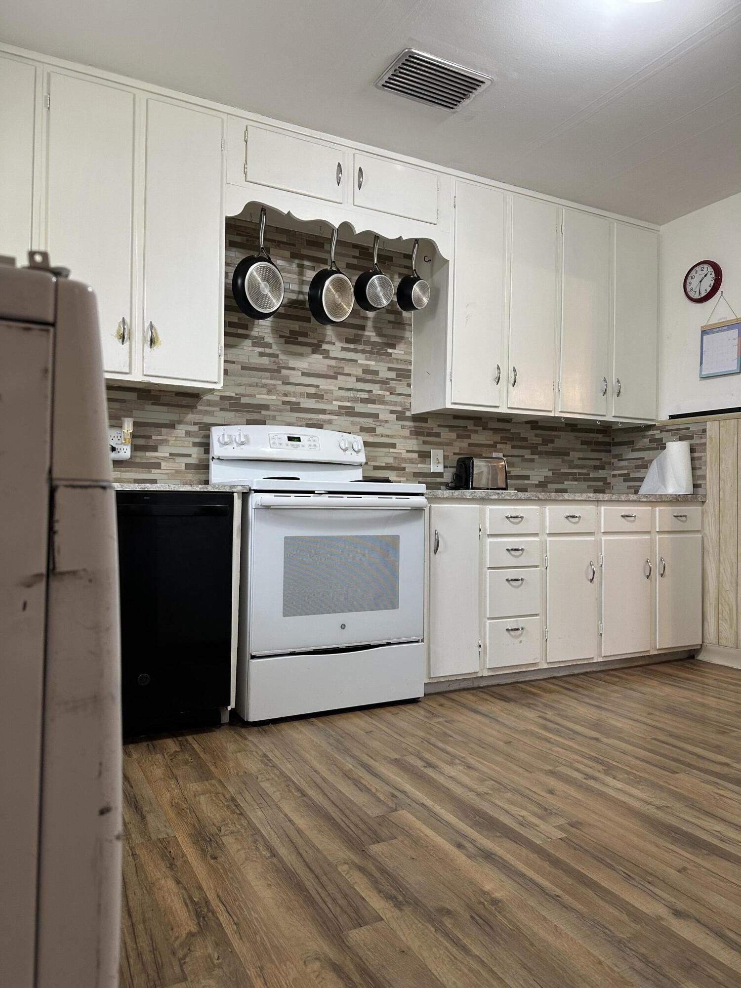 1907 38th Street Lubbock, TX 79412 - Photo 14 of 36 a kitchen with stainless steel appliances granite countertop a sink and cabinets