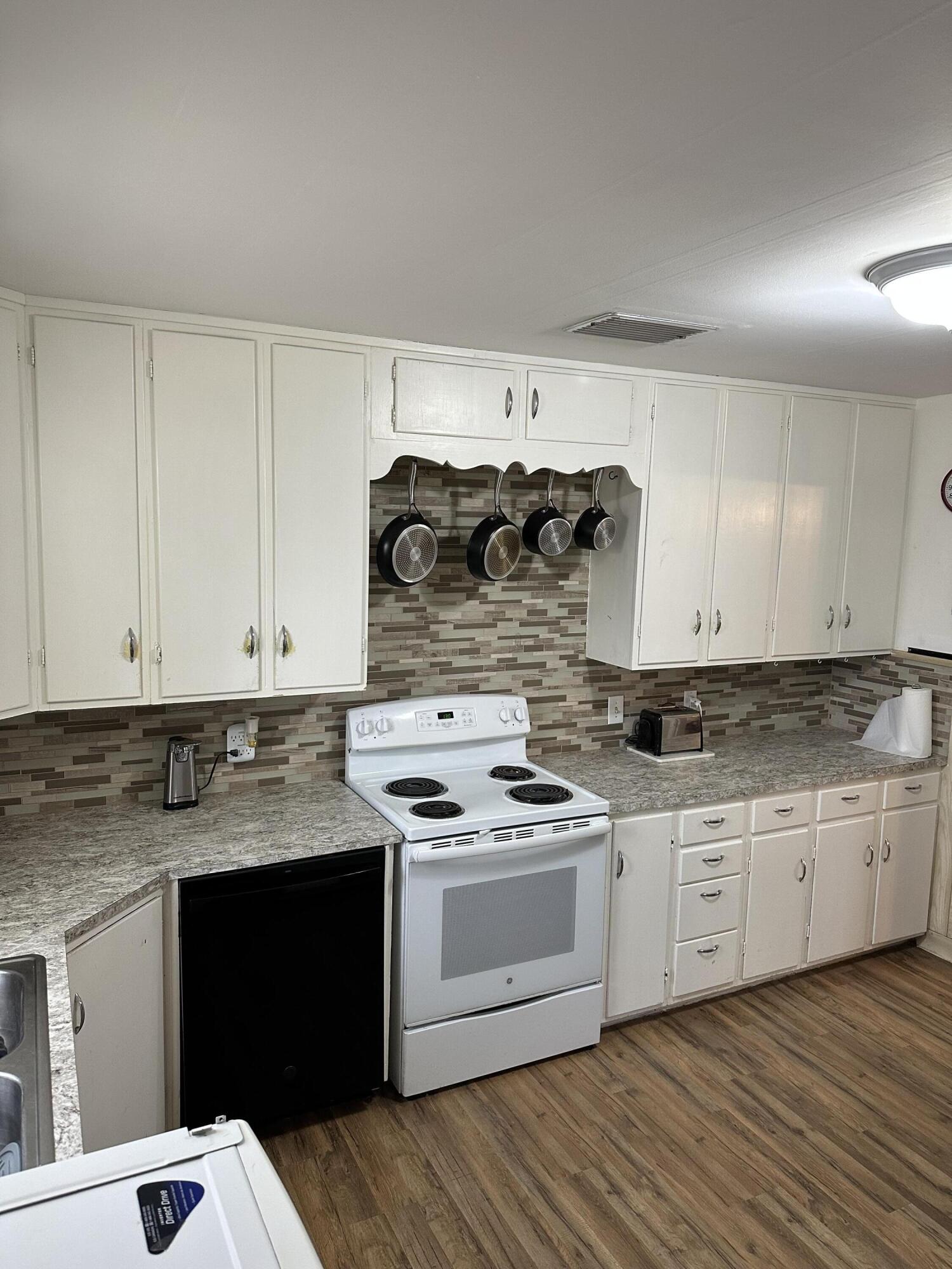 1907 38th Street Lubbock, TX 79412 - Photo 17 of 36 a kitchen with granite countertop white cabinets and white appliances