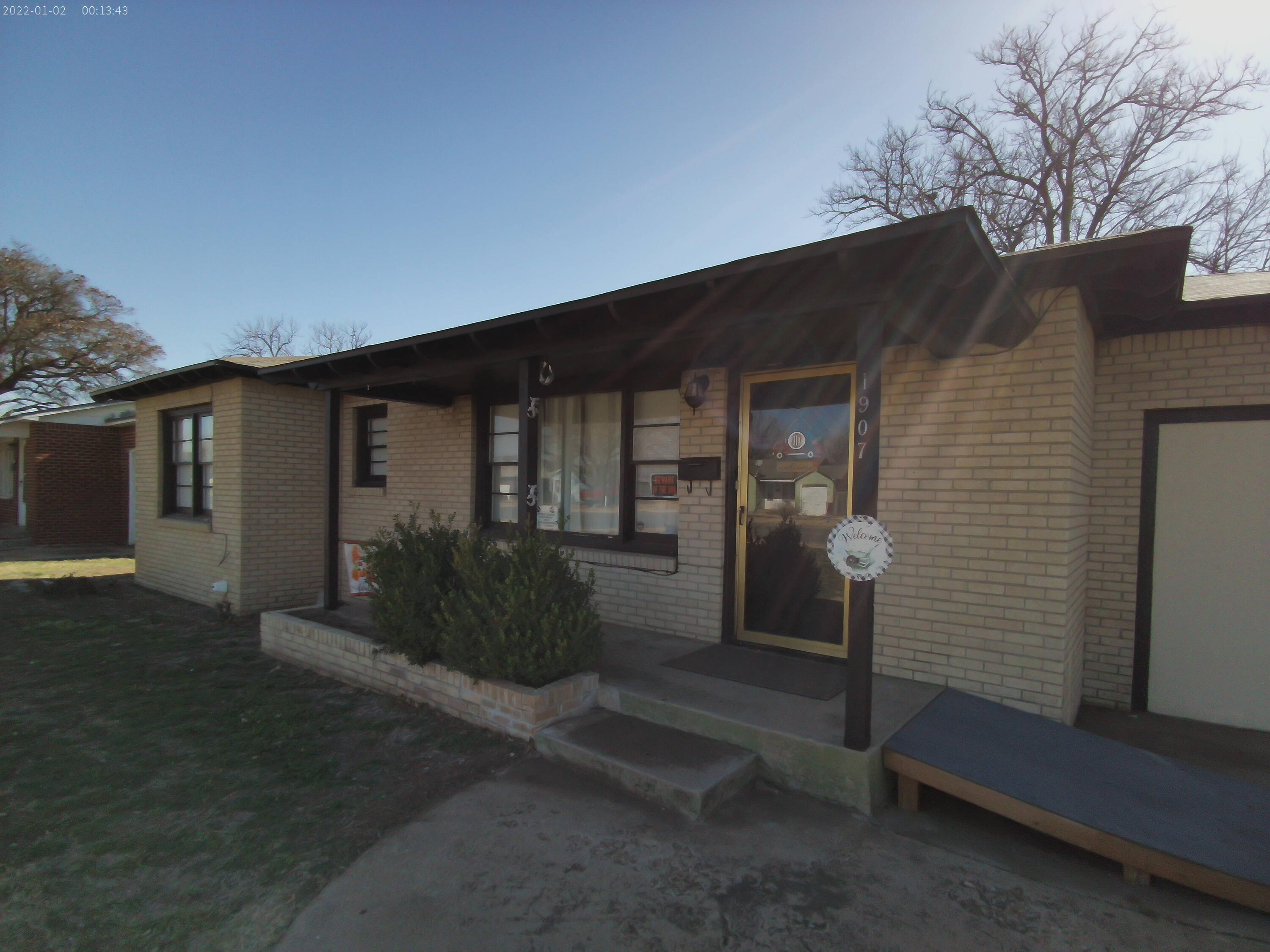 1907 38th Street Lubbock, TX 79412 - Photo 2 of 36 a front view of a house with garden
