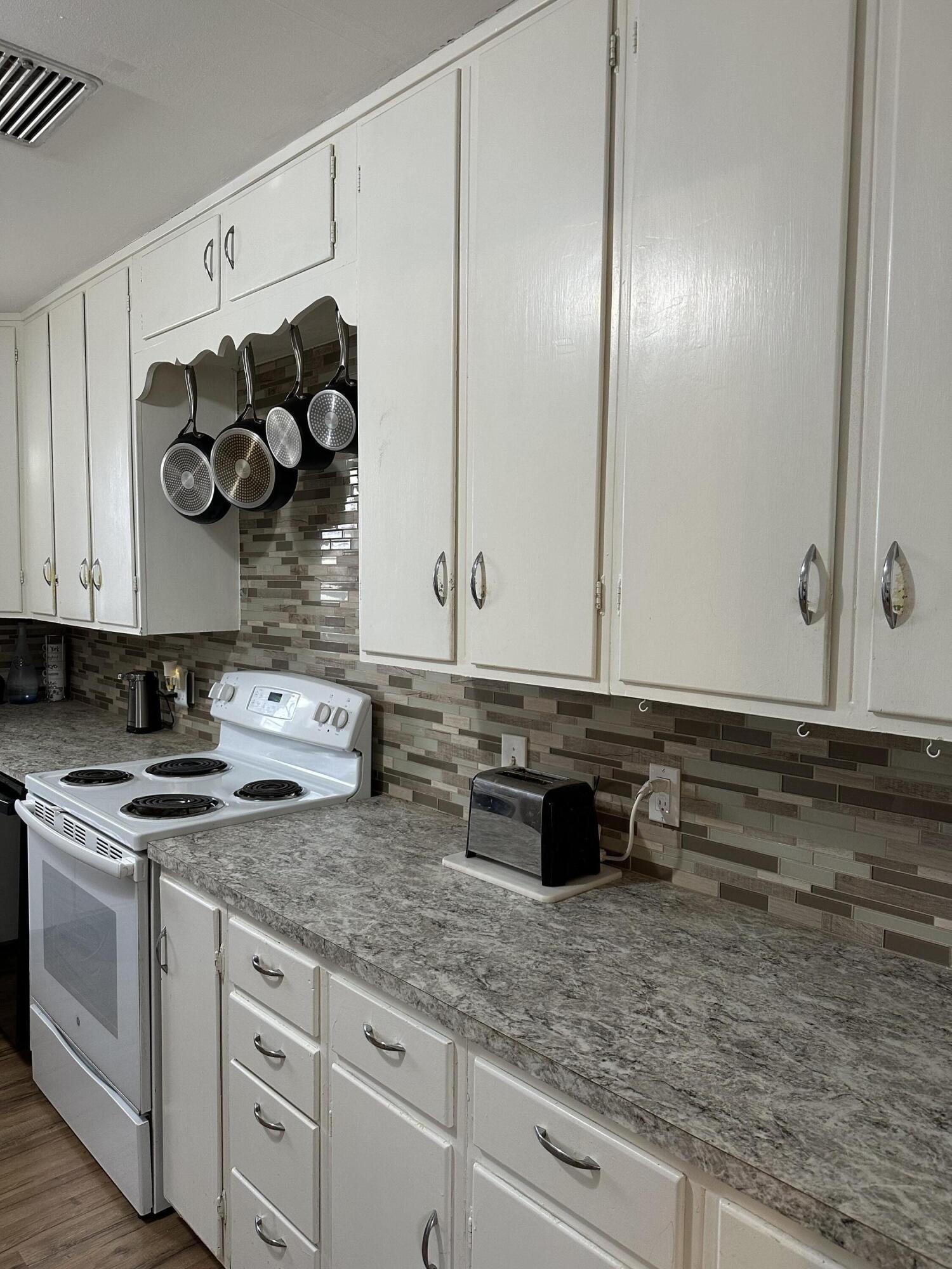 1907 38th Street Lubbock, TX 79412 - Photo 21 of 36 a kitchen with a sink and cabinets