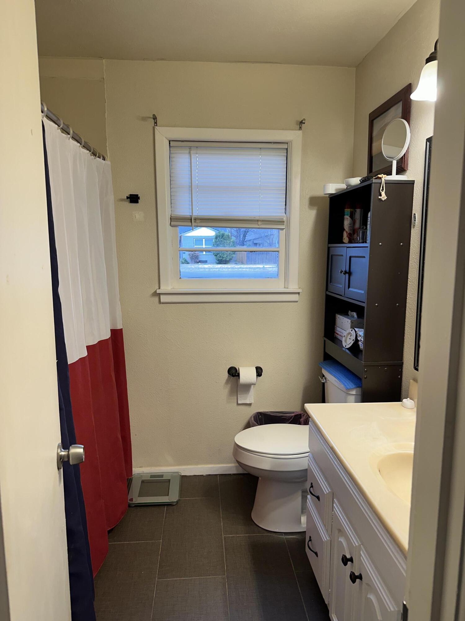1907 38th Street Lubbock, TX 79412 - Photo 25 of 36 a bathroom with a toilet a sink and bathtub