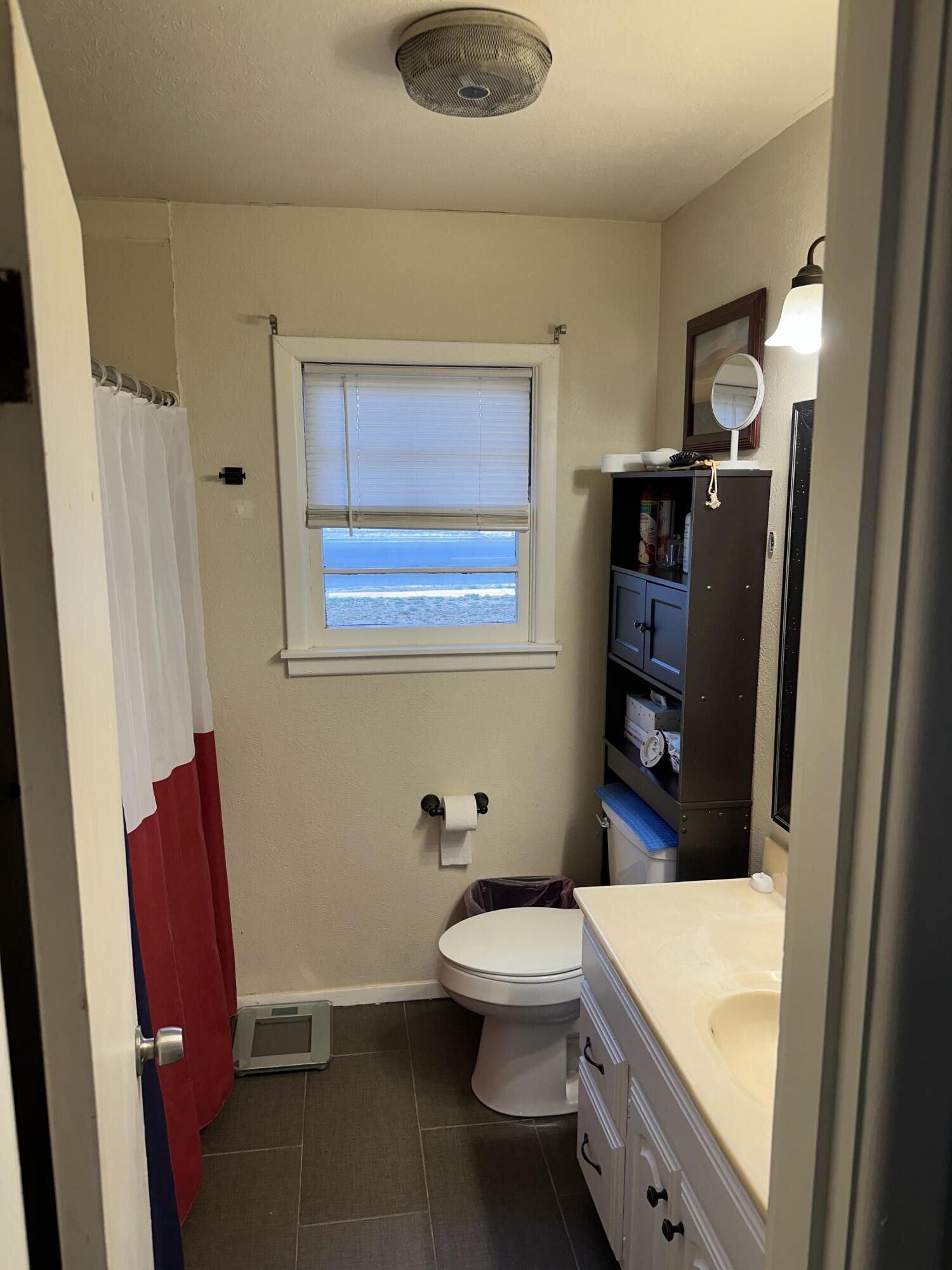 1907 38th Street Lubbock, TX 79412 - Photo 26 of 36 a bathroom with a toilet a sink and bathtub