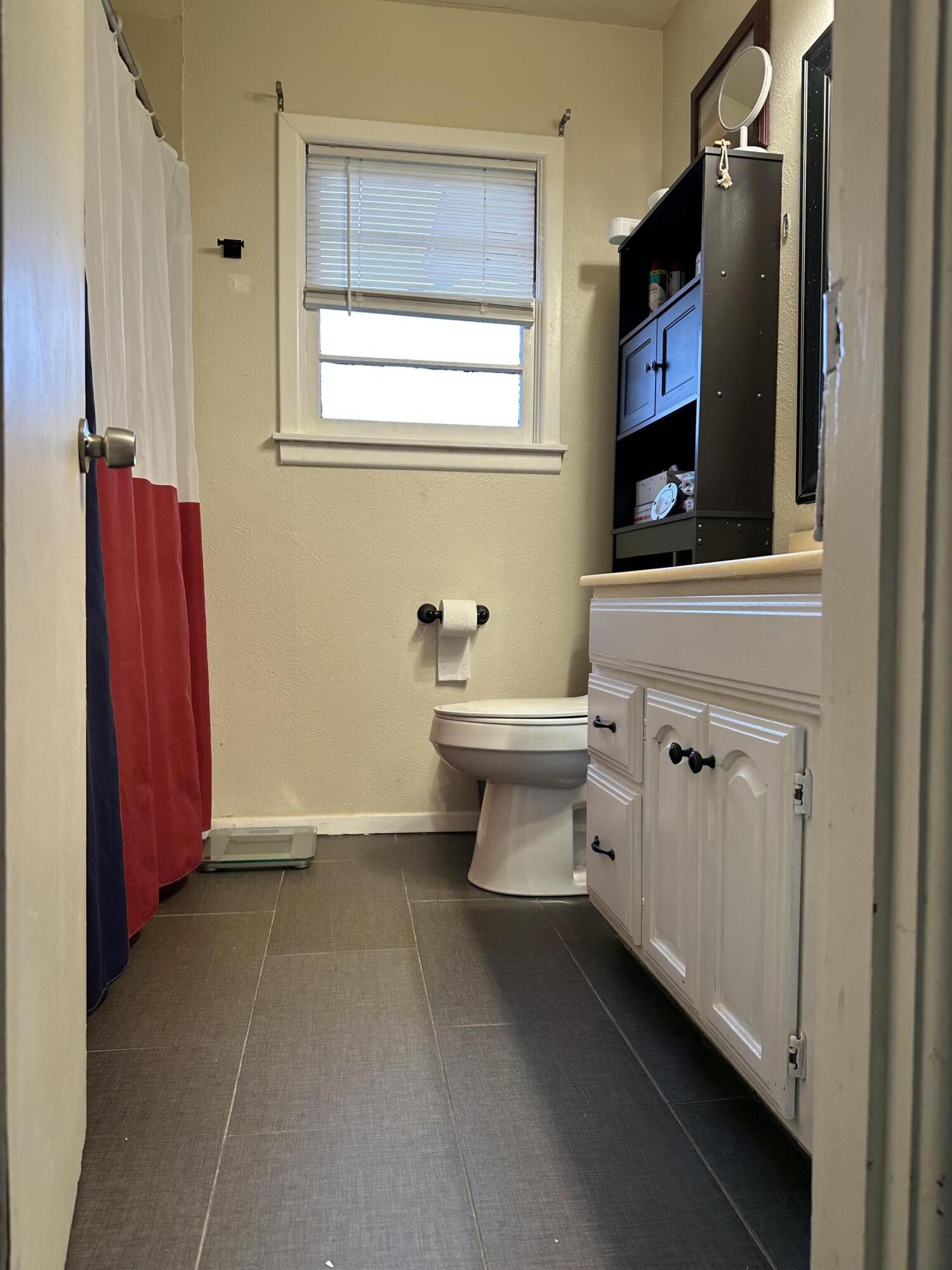 1907 38th Street Lubbock, TX 79412 - Photo 27 of 36 a bathroom with a sink and a mirror
