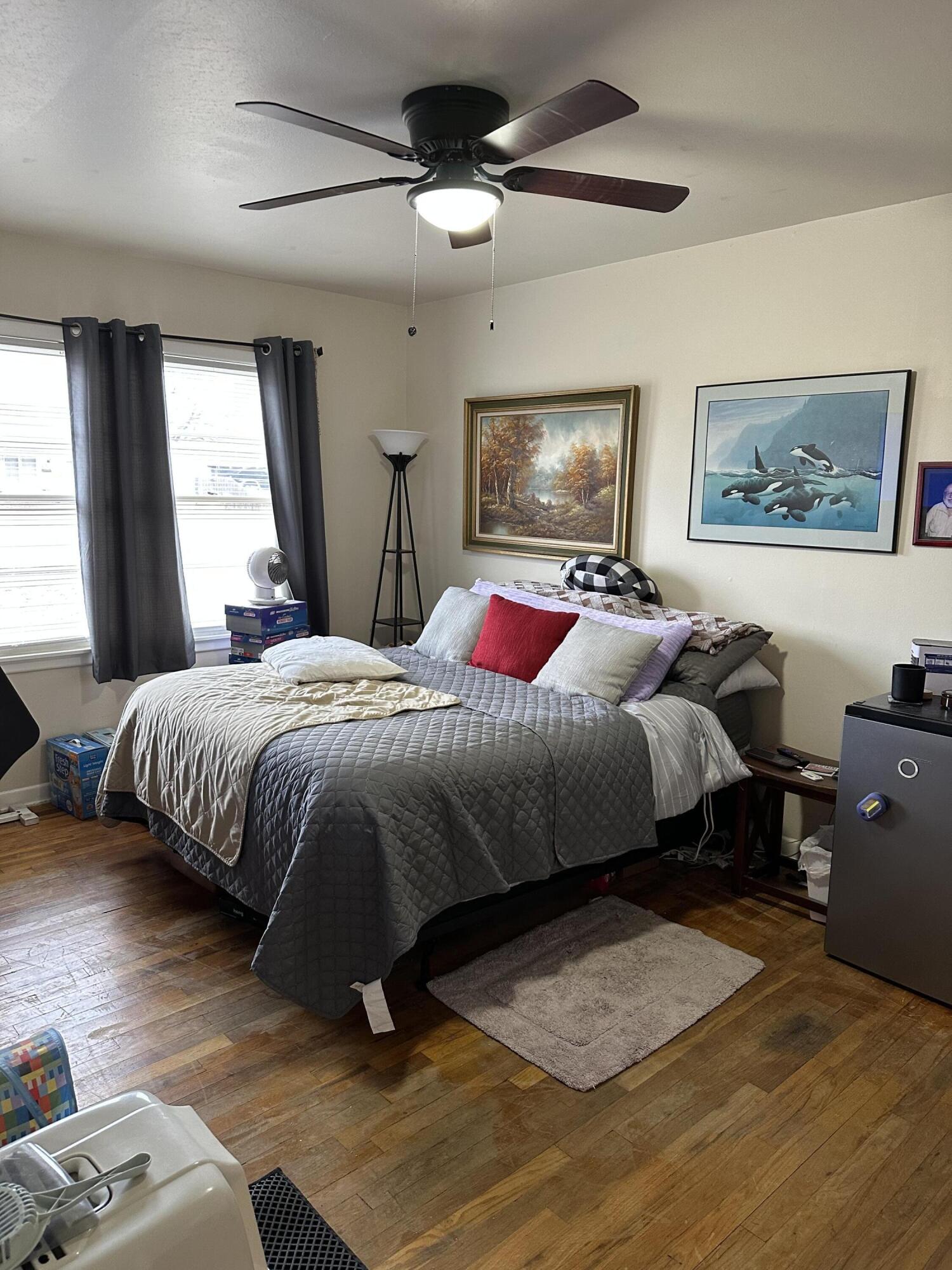1907 38th Street Lubbock, TX 79412 - Photo 28 of 36 a bedroom with bed and a chandelier
