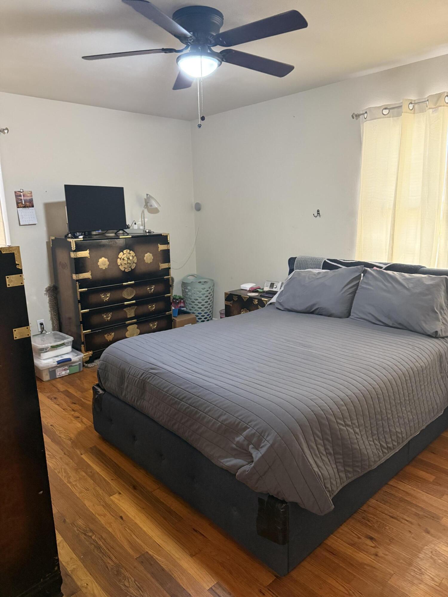1907 38th Street Lubbock, TX 79412 - Photo 34 of 36 a bedroom with a bed and a flat screen tv