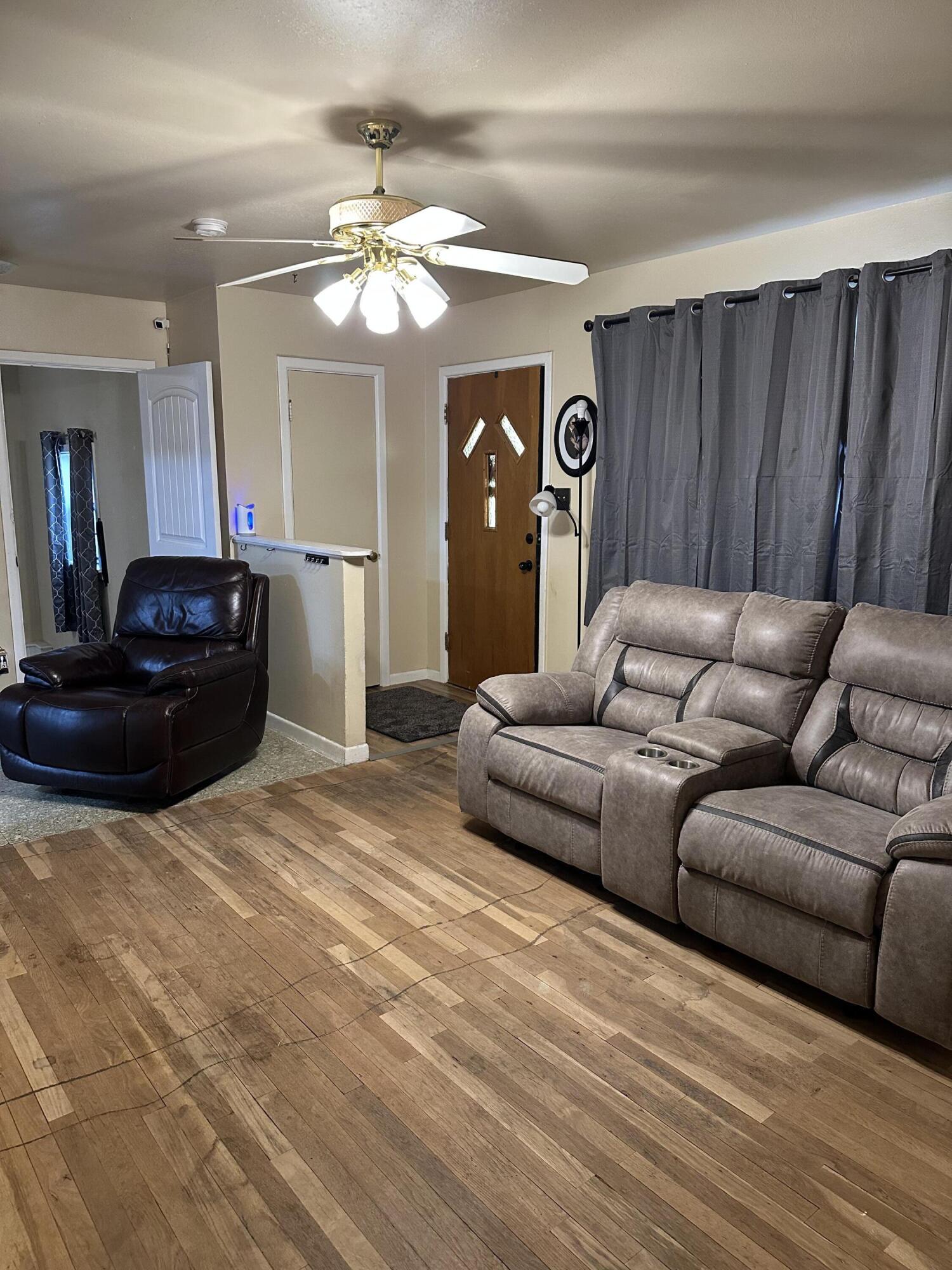 1907 38th Street Lubbock, TX 79412 - Photo 4 of 36 a living room with furniture and a chandelier