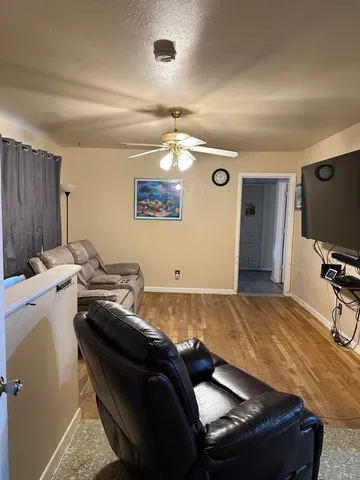 a living room with furniture and a chandelier