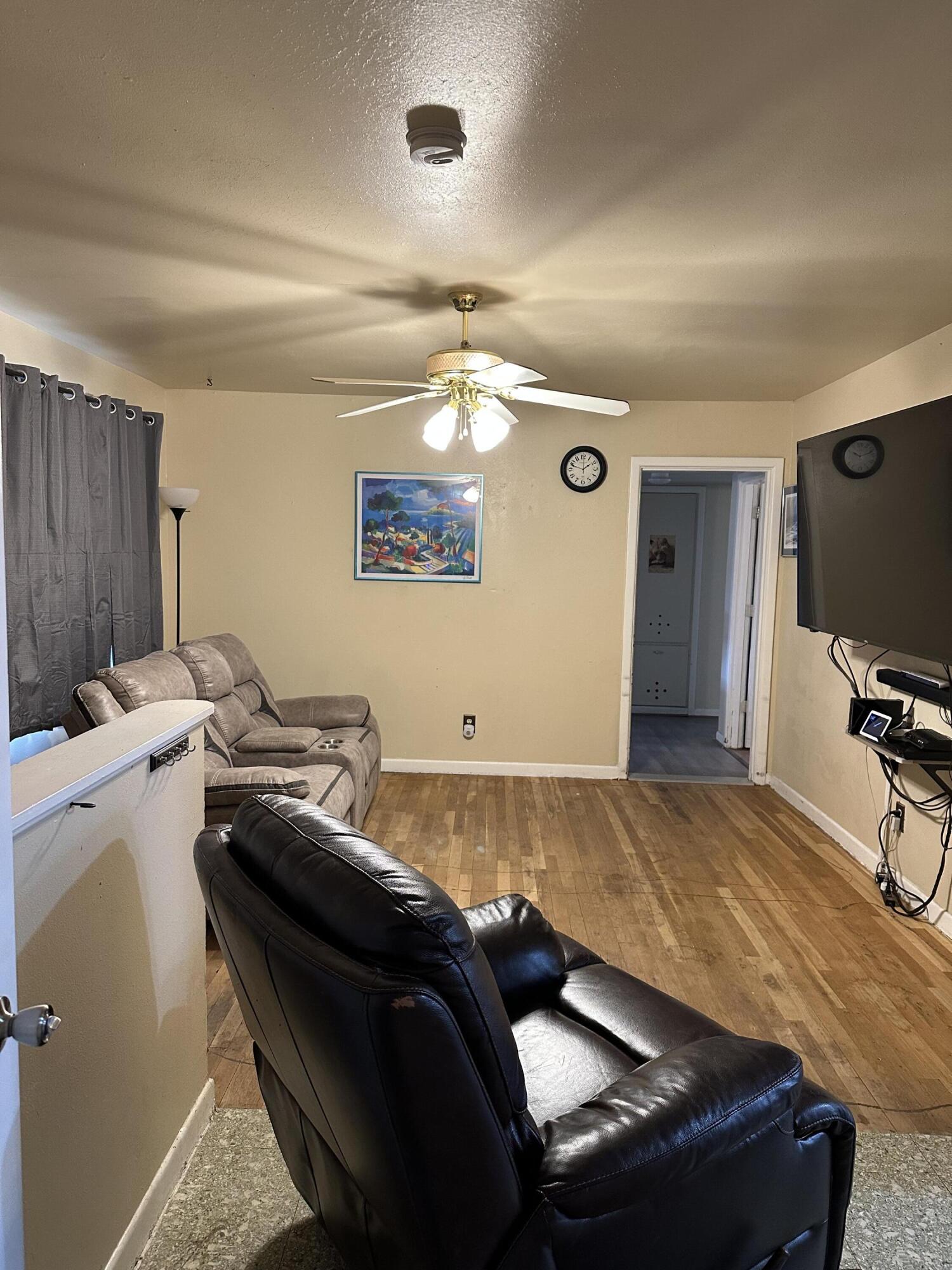 1907 38th Street Lubbock, TX 79412 - Photo 9 of 36 a living room with a bed furniture and a flat screen tv