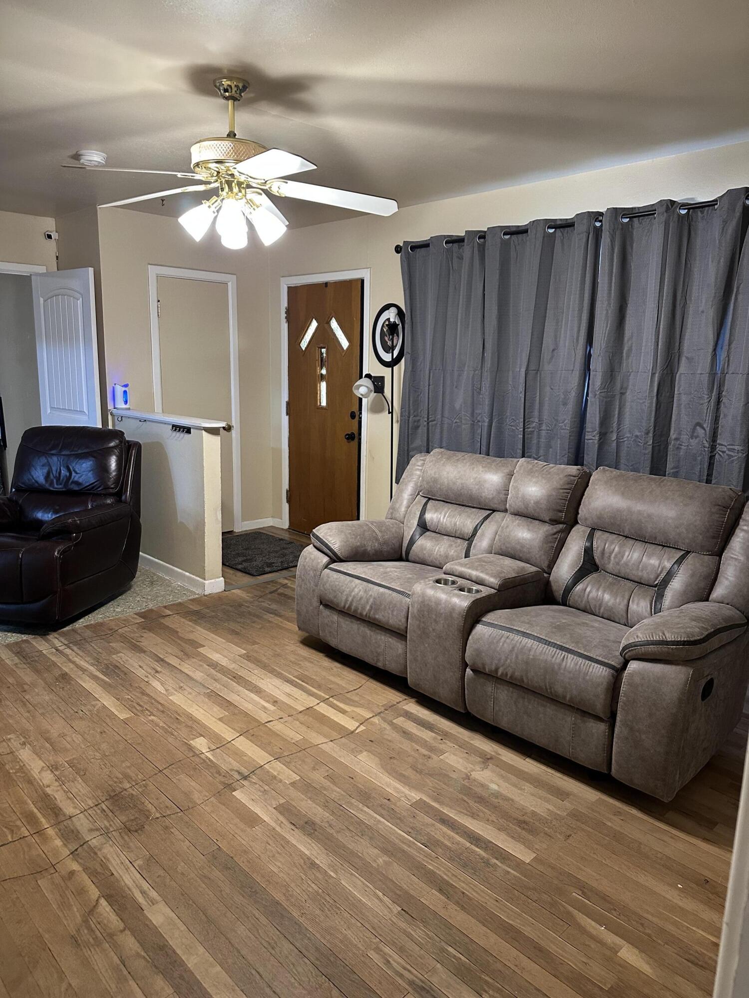 1907 38th Street Lubbock, TX 79412 - Photo 10 of 36 a living room with furniture and a chandelier