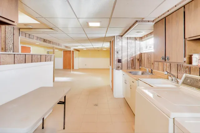a large white kitchen with a large window