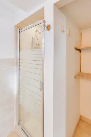 a bathroom that has a glass shower door
