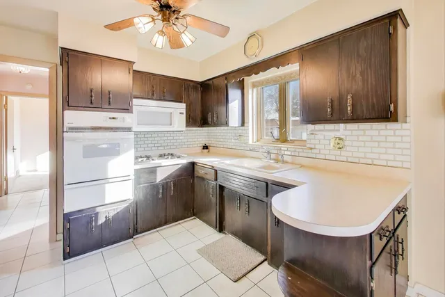 a kitchen with a sink appliances and cabinets