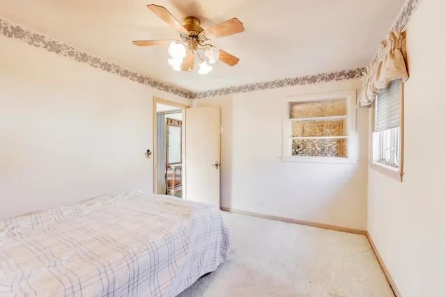 a spacious bedroom with a bed and a chandelier