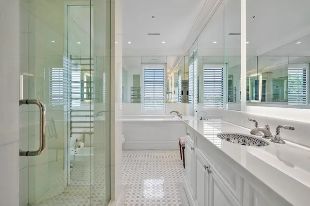 a bathroom with a granite countertop sink and a shower