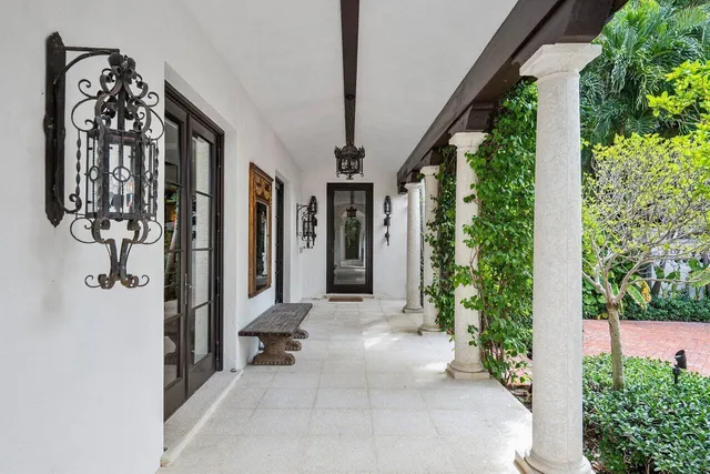a view of a entryway door with flower in front of house