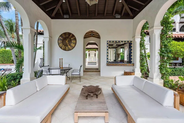 a living room with furniture and a clock
