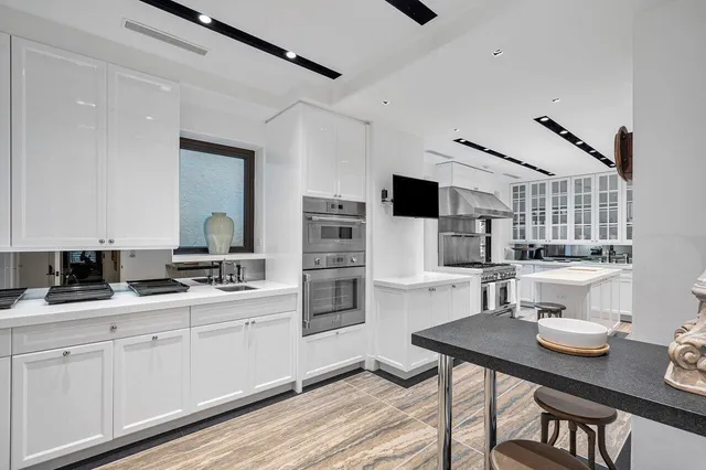 a kitchen with stainless steel appliances a sink and stove